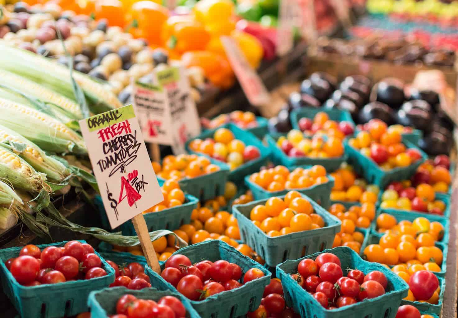 A colorful display of cherry tomatoes at a farmers market. 