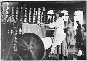 Historic black and white photo of two women working at Lowell Mill No. 5 and Lowell mill girls