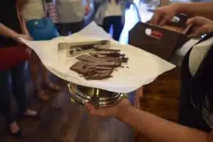 Someone holds a platter full of chocolate bars on Off the Beaten Path Food Tours' Jamaica Plain Vegan Chocolate Tour.