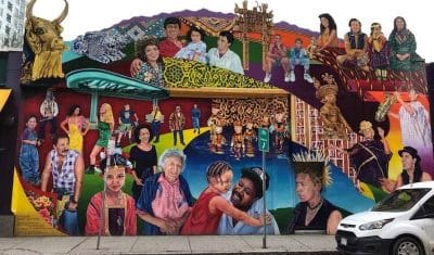 A large colorful mural of various people as seen in Central Square, Cambridge, MA.