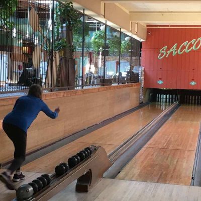 A person throws a bowling ball at Saccos in Davis Square, Somerville. 