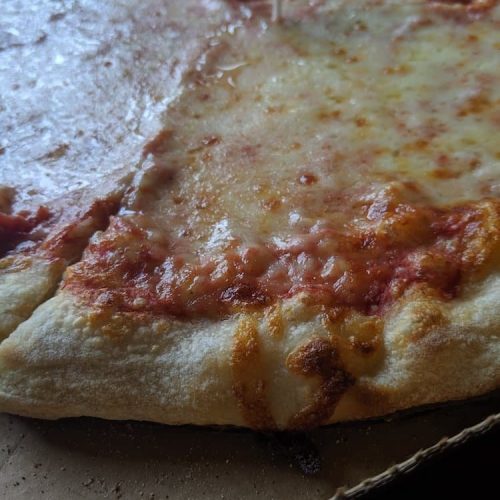 A close up of a cheese pizza as seen on Off the Beaten Path Food Tours' Fenway Neighborhood Food Tour.