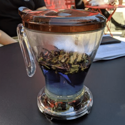 blue pea powder tea inside a tea maker