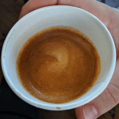 cortado espresso in a cup with latte art birds eye view